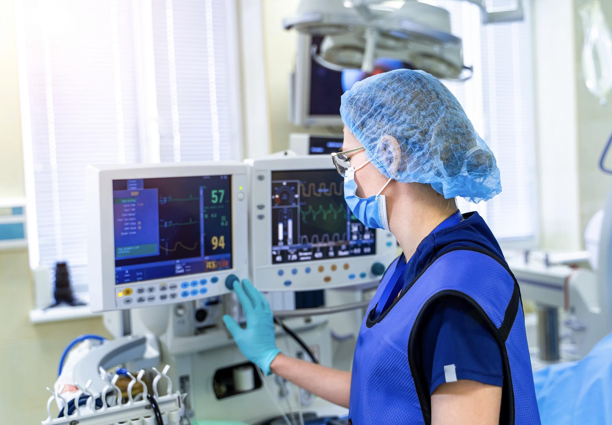 Healthcare nurse operating medical equipment in a pharmaceutical environment