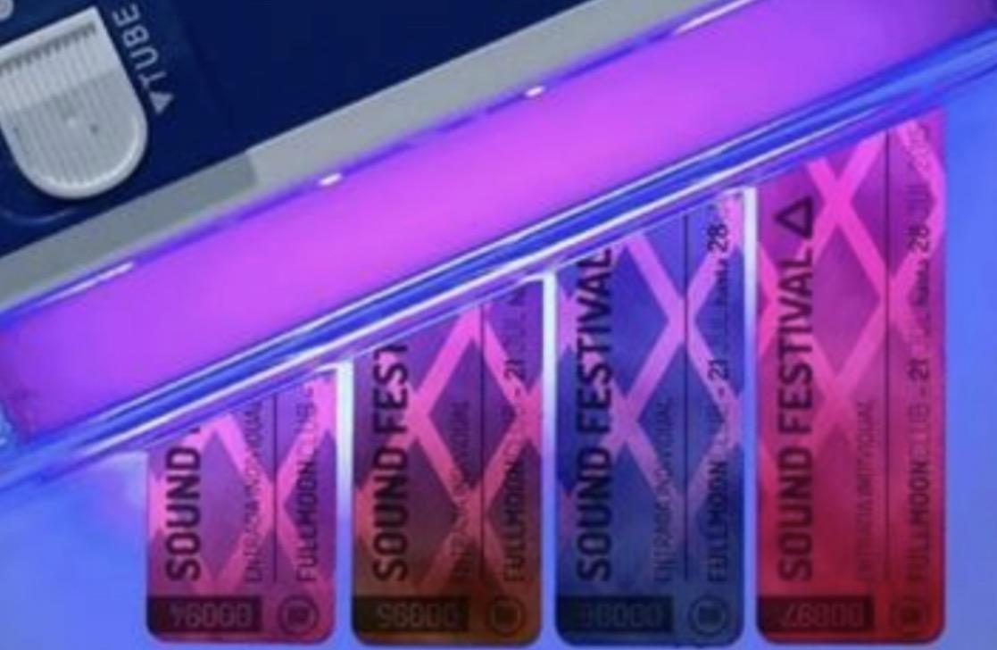 Tamper-evident UV-reactive security label shown under ultraviolet illumination