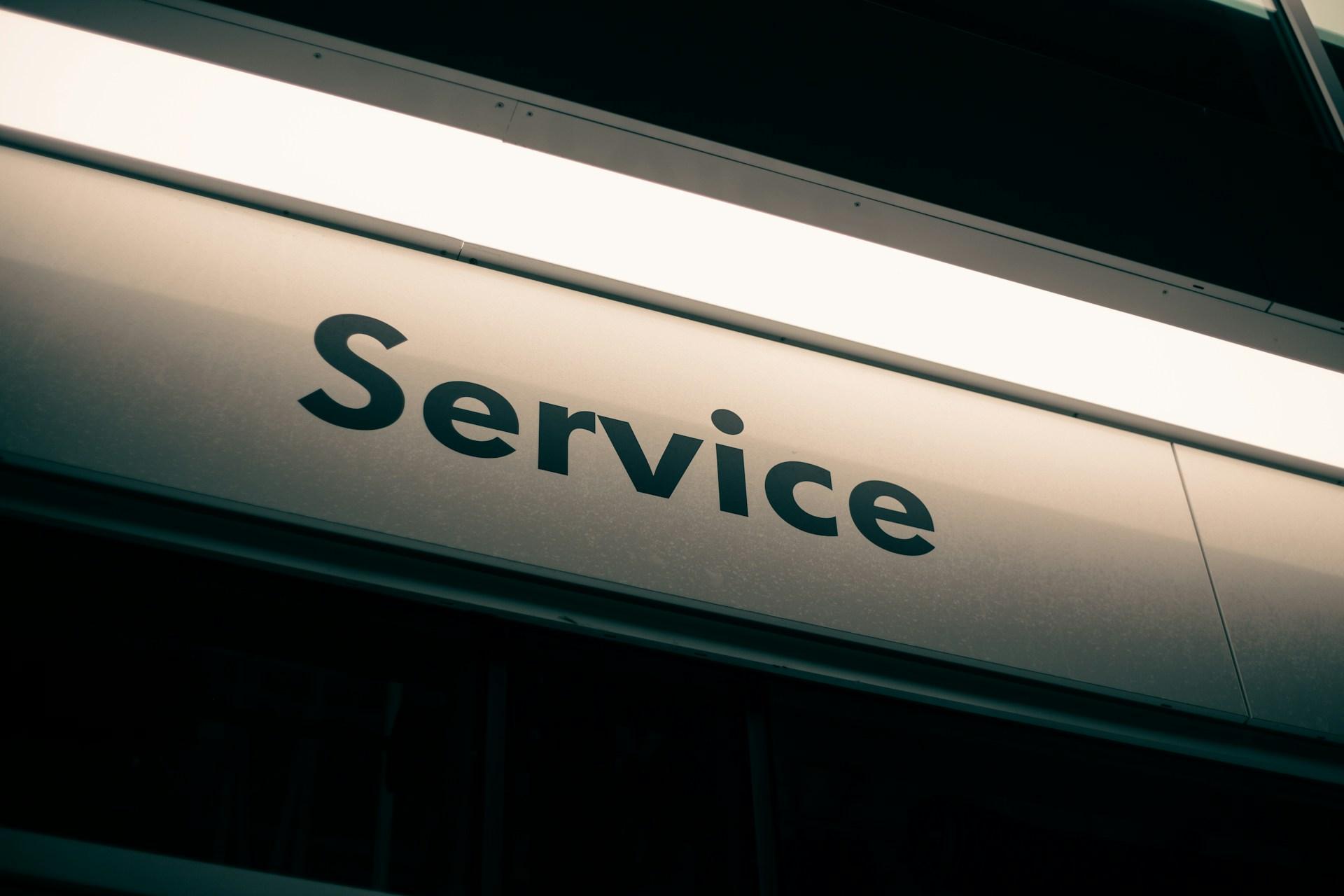 Neon lit Service sign representing Protectaseal customer service and support